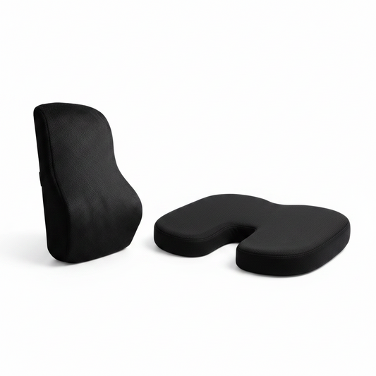 Black office chair cushion on a desk and another on an office chair.
